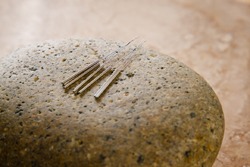 acupuncture needles on a rock